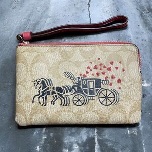 COACH Corner Zip Wristlet In Signature Canvas With Horse & Carriage Hearts Motif